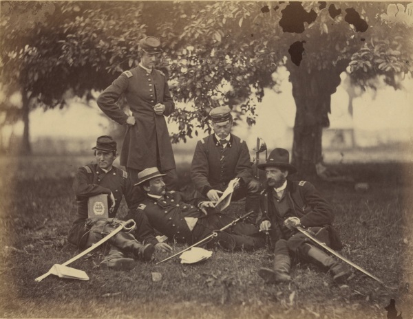 Alexander Gardner took this photograph at Fairfax Court House in June 1863, just before the start of the Gettysburg Campaign. He called it "Studying the Art of War." Ulric Dahlgren is the man standing. The man in the center is Count Ferdinand von Zeppelin, in the United States to observer. He will later become famous for the airships he develops. At the far right is Lt. Rosencranz, who will later serve on Meade's staff. Theodore Lyman mentions him often in his writings. To read Gardner's extensive caption for this photo, see below (Library of Congress).
